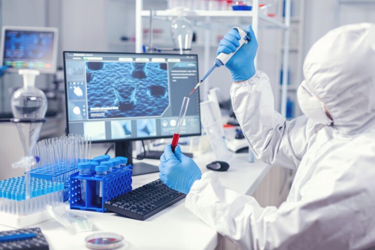 medical engineer using dispenser take sample blood from test tube lab